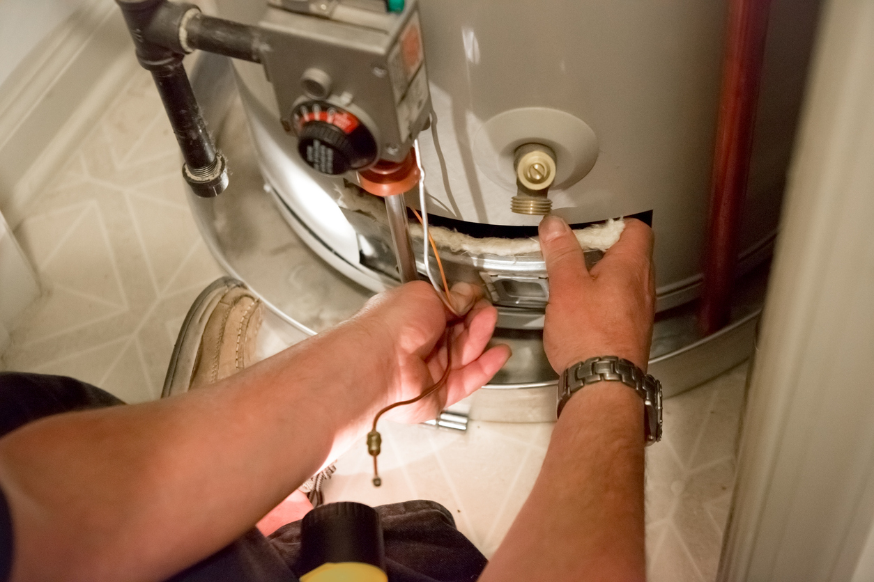 Plumber inspecting a hot water heater