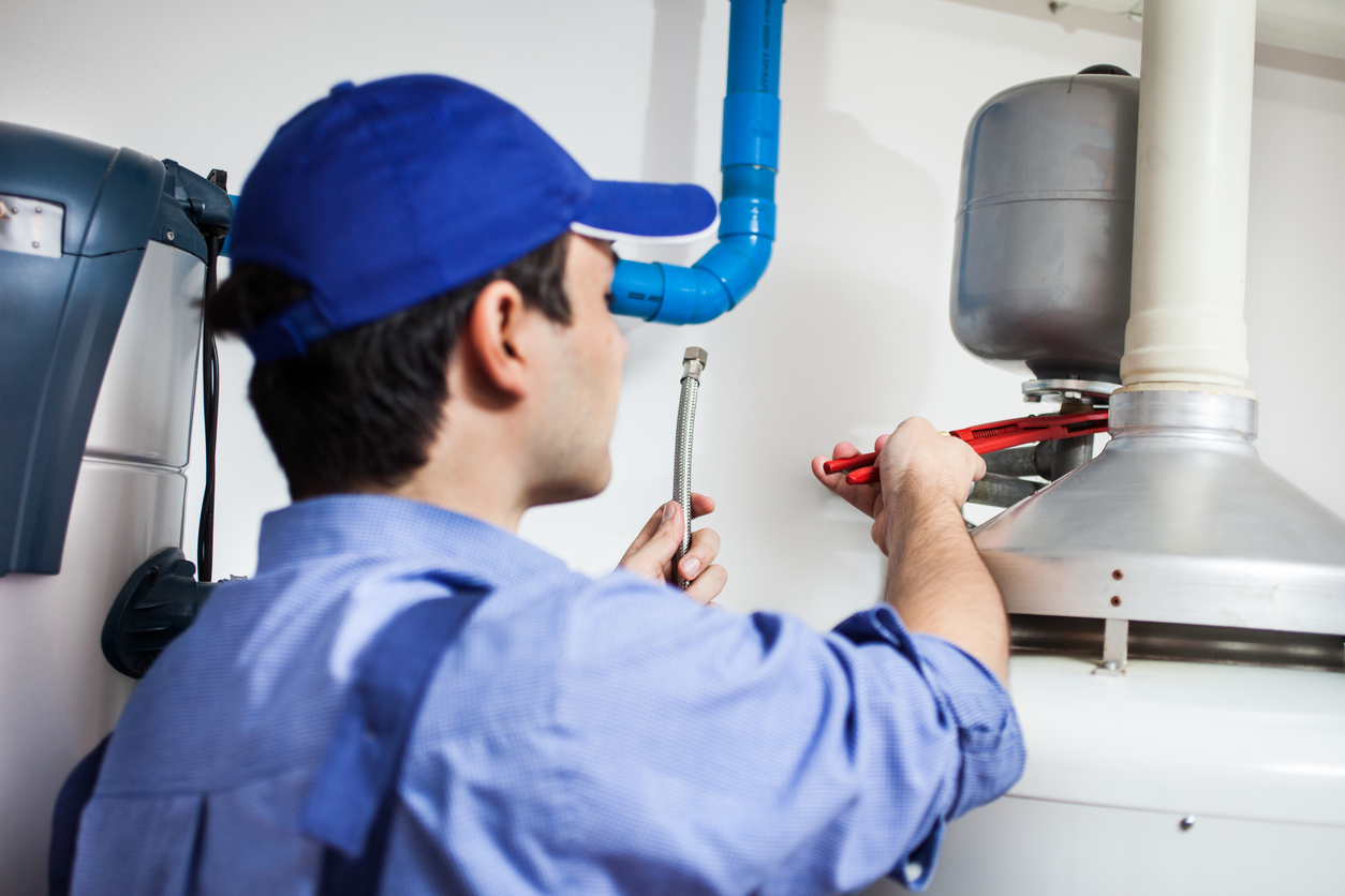 Technician repairing hot water heater