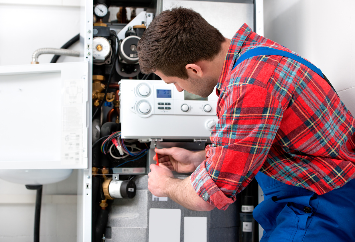 Technician servicing a boiler