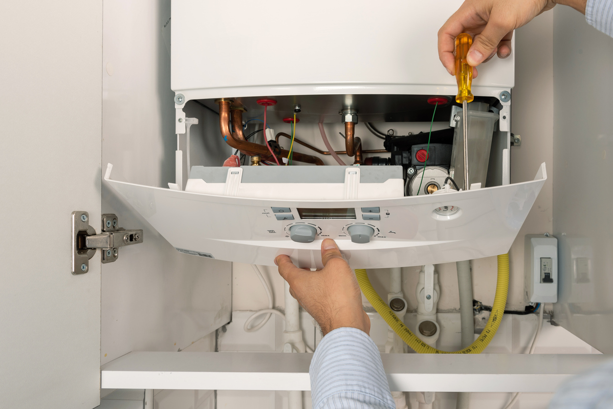 Technician repairing gas boiler