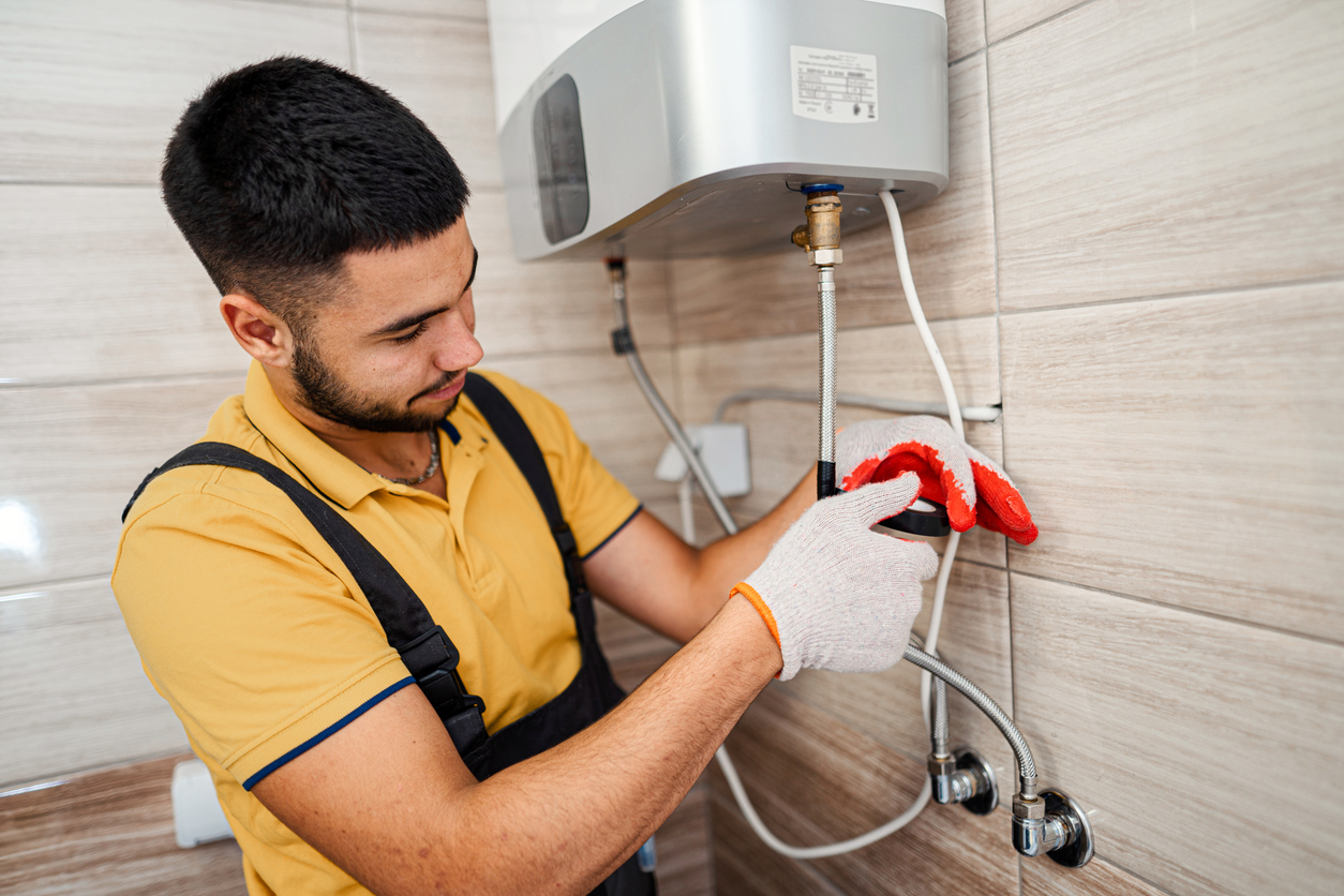 Technician repairing hot water heater