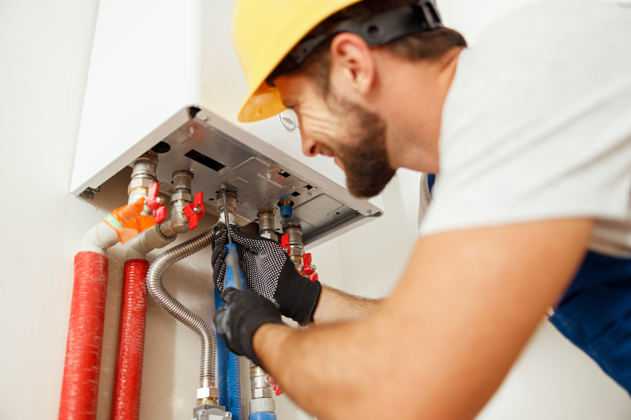 Plumber fixing water heater