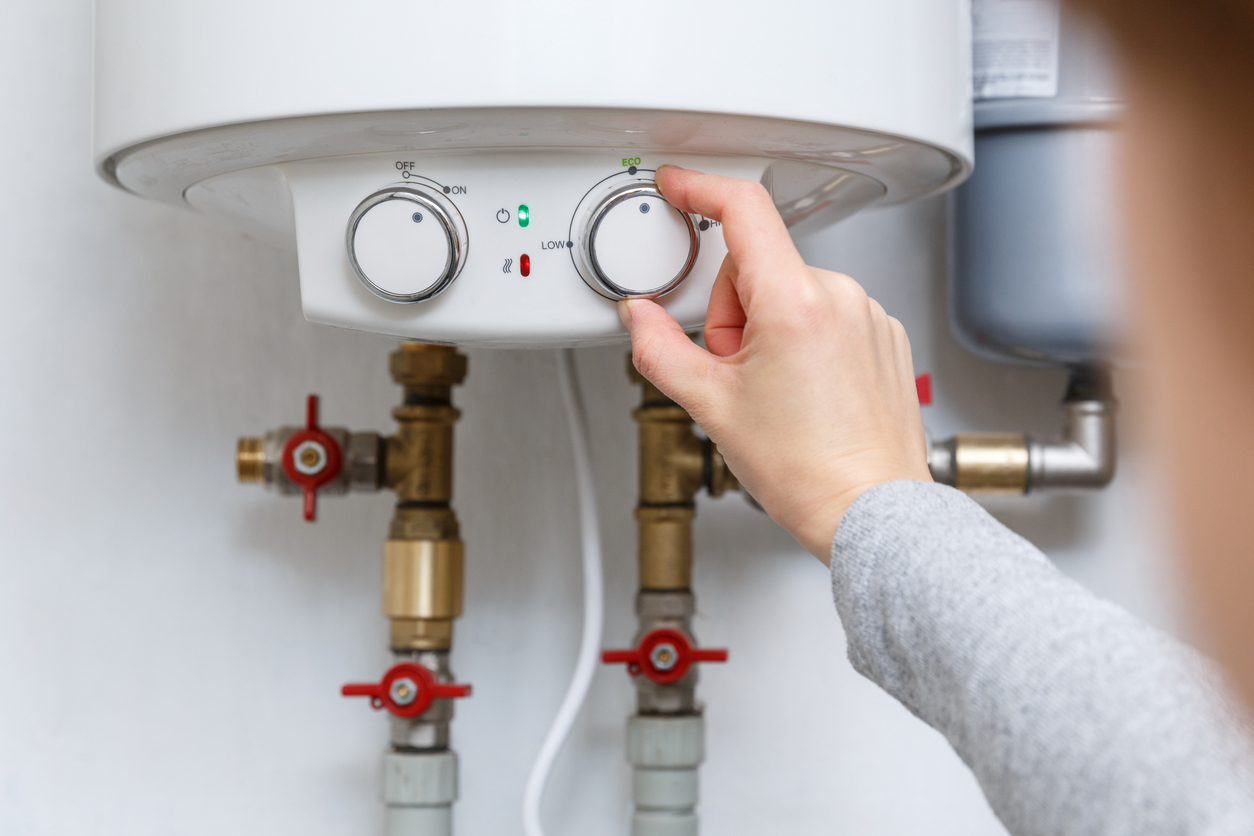 Plumber inspecting electric water heater