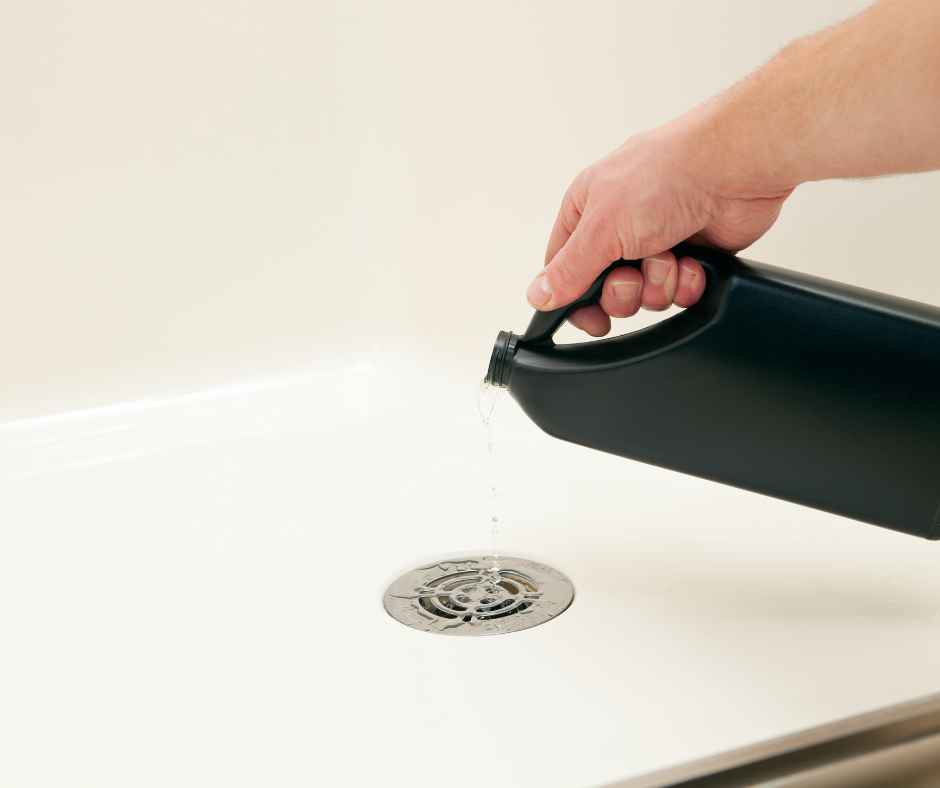 Pouring a chemical drain cleaner